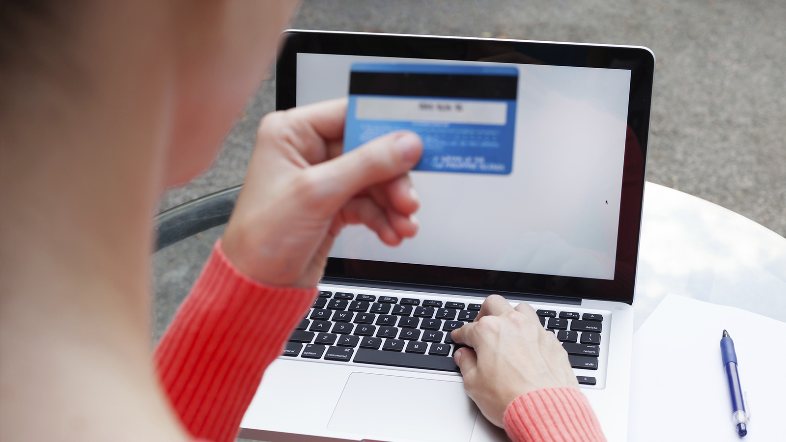card-back-cvv2-1600x900 Woman at laptop checking Card Verification Value 2 of Visa card.