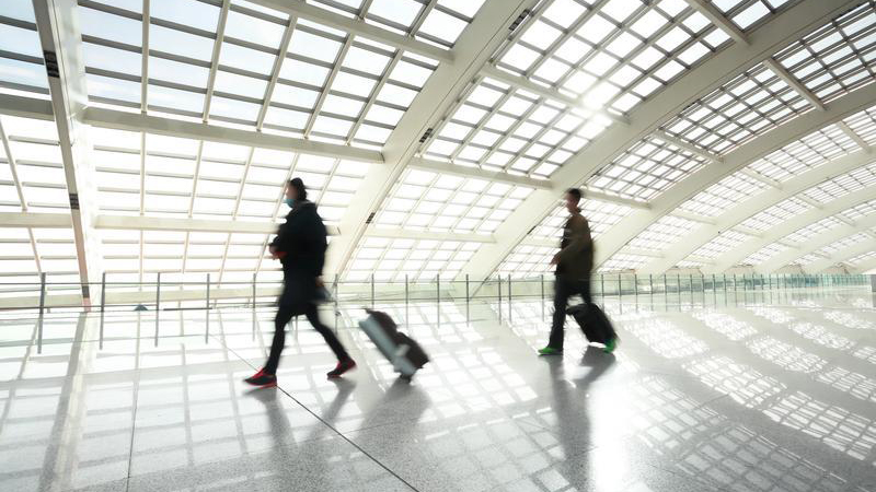 People walking through airport.