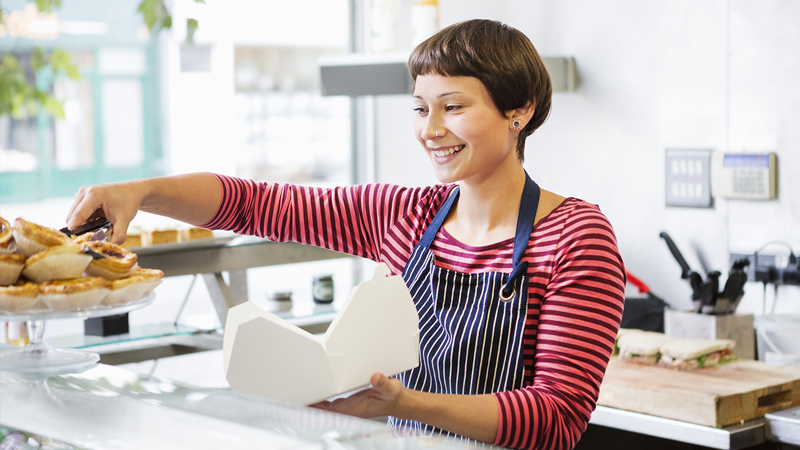 bakery owner serving a customer and smiling bakery owner serving a customer and smiling