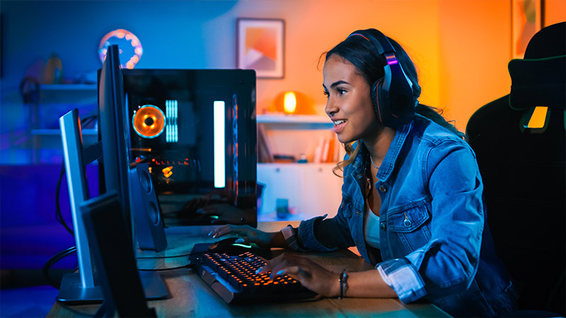 Teenager playing gamer on a computer