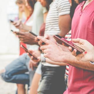Pessoas mexendo em seus celulares