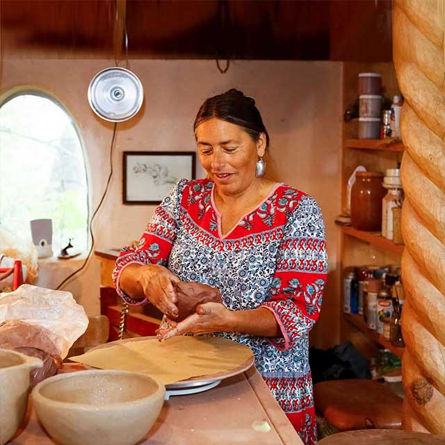 Woman shaping clay