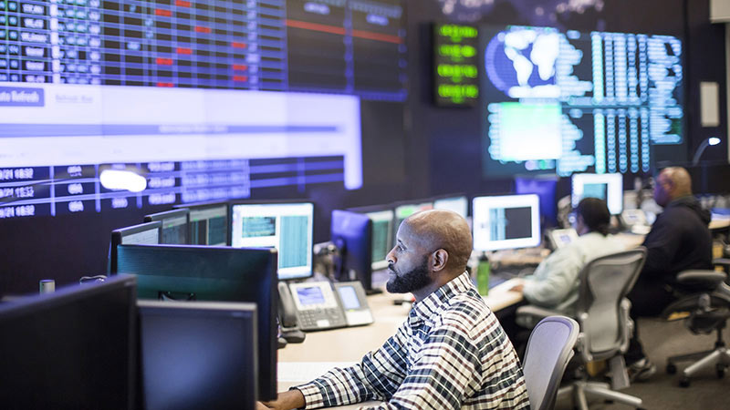 Network operations center (NOC) technicians monitoring critical network elements and engaging in proactive network systems monitoring.