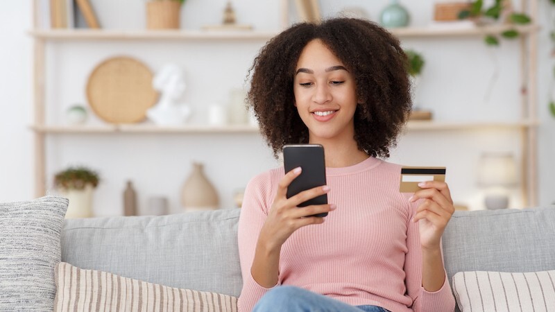 Woman making payment with card on phone